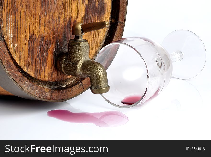 A red wine barrel, isolated in white. Wine was spilled from the tap.