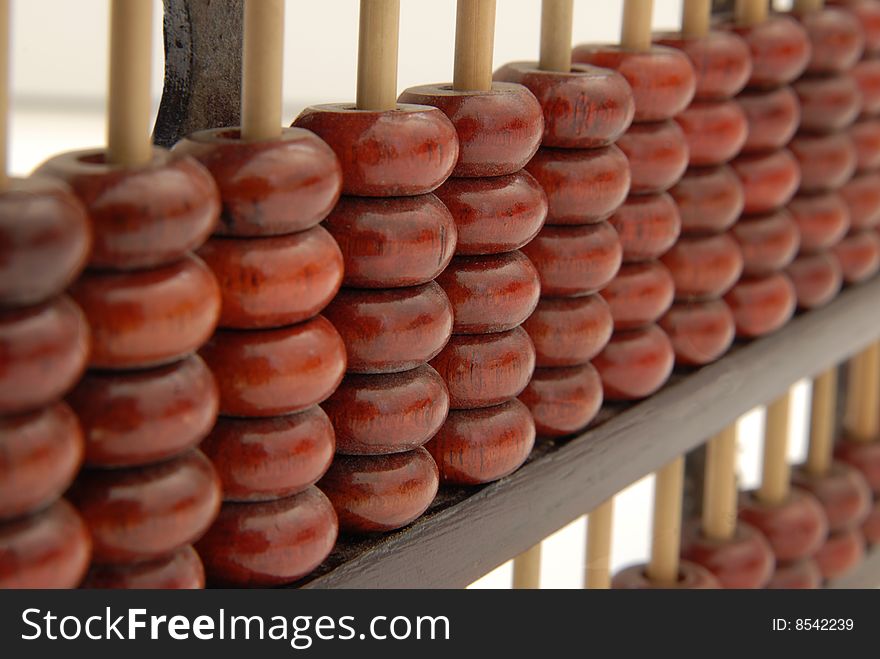 A wooden abacus in a studio shot, isolated on white. A wooden abacus in a studio shot, isolated on white.