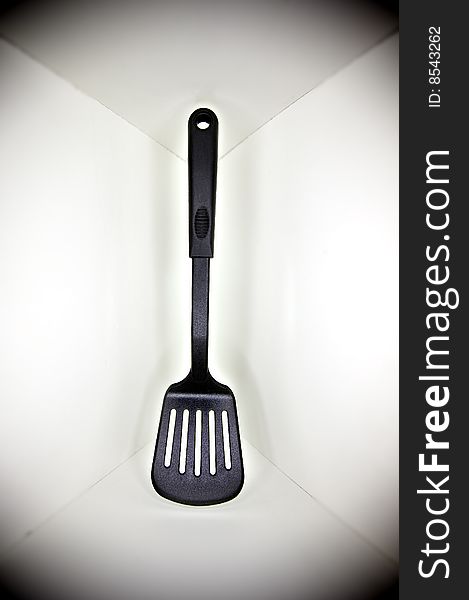Black plastic spatula, floated in a white cornered background, with a surrounding shadow. Black plastic spatula, floated in a white cornered background, with a surrounding shadow.