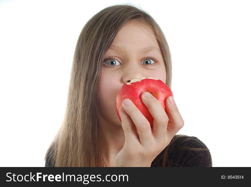 The cute little girl eating the apple. The cute little girl eating the apple