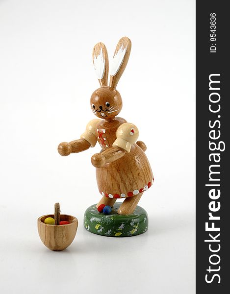 Easter rabbit with basket and easter eggs against white background