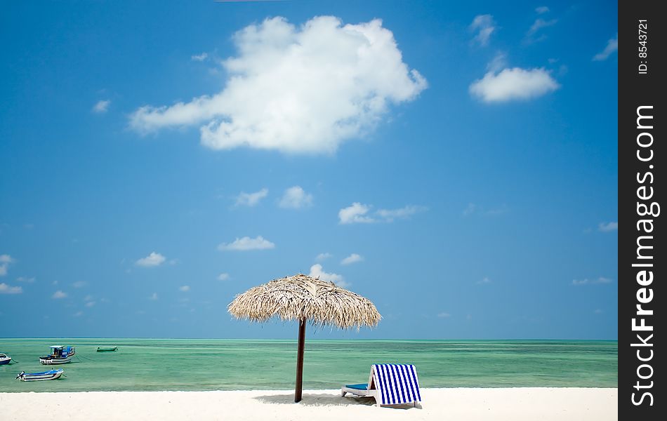 Parasol and bed on beautiful tropical  beach. Parasol and bed on beautiful tropical  beach