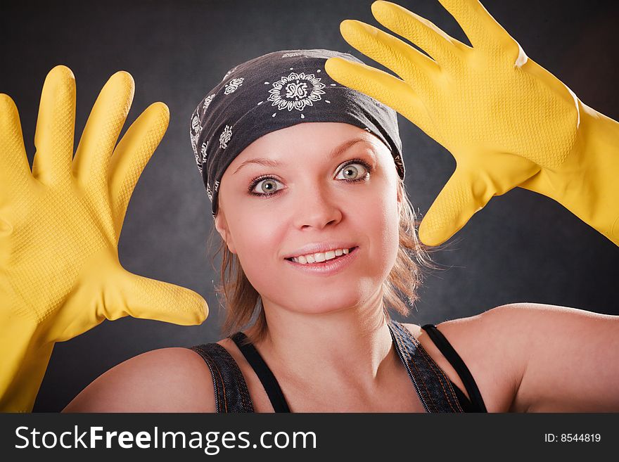 Young smiling woman with yellow rubber gloves