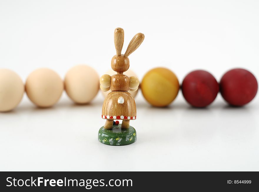 Easter bunny painting eggs on white background. Easter bunny painting eggs on white background