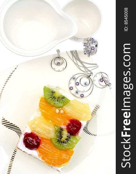 Jewels on plate with delicious cake. Jewels on plate with delicious cake