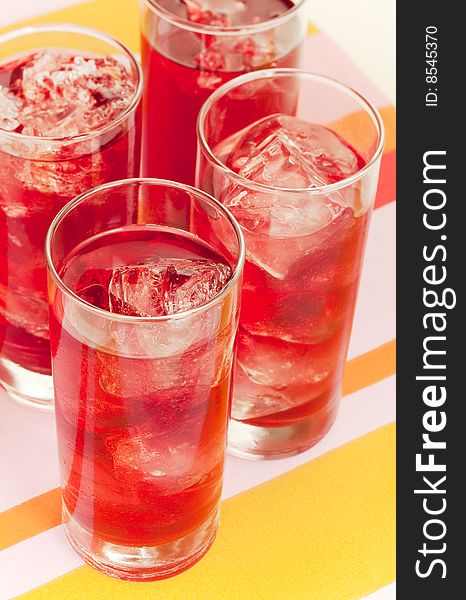 Chilled red beverage with ices on the tall glass