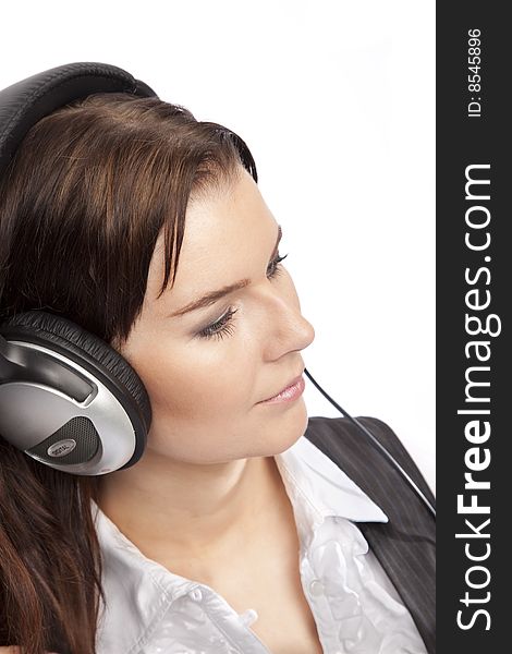 Isolated young business woman listening music over white background