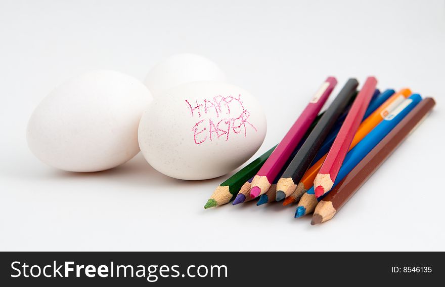 Still life of white eggs in the process of being decorated with color pencils and crayon for Easter. Still life of white eggs in the process of being decorated with color pencils and crayon for Easter