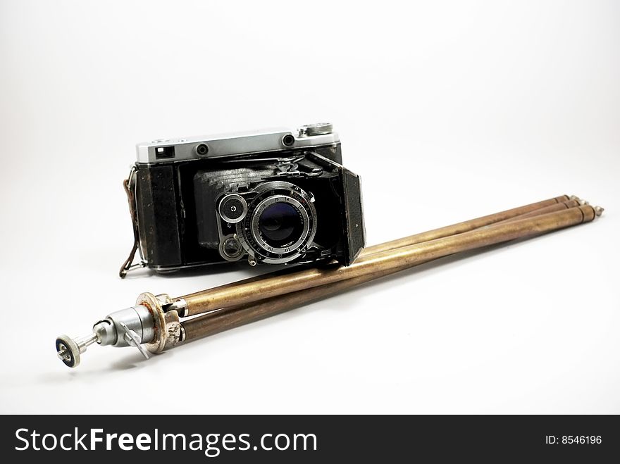 Old film photo camera and stand isolated on a white background