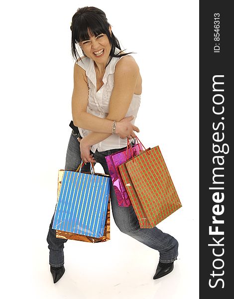 Attractive young woman making shopping embracing herself with lots of colorful shopping bags, smile and casual wear. Isolated on white. Attractive young woman making shopping embracing herself with lots of colorful shopping bags, smile and casual wear. Isolated on white.