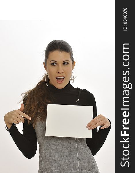 Attractive woman in business wear, holding a blank sign and byting it with very surprised or pleased expression. Attractive woman in business wear, holding a blank sign and byting it with very surprised or pleased expression