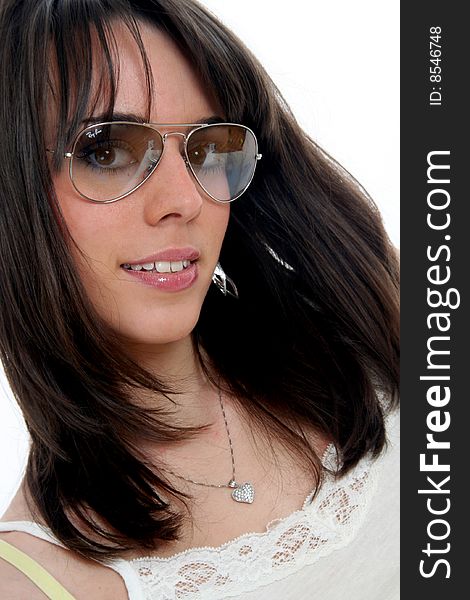 Portrait of a young woman with lovely smile and glance, wearing trendy sunglasses. Hazel eyes and long brown hair. Isolated on white. Portrait of a young woman with lovely smile and glance, wearing trendy sunglasses. Hazel eyes and long brown hair. Isolated on white.