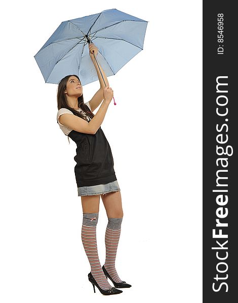 Lovely young fashion model opening his blue umbrella. White background. Black and white t-shirt and jeans mini skirt, long striped socks and high heels shoes. Full body portrait. Lovely young fashion model opening his blue umbrella. White background. Black and white t-shirt and jeans mini skirt, long striped socks and high heels shoes. Full body portrait.