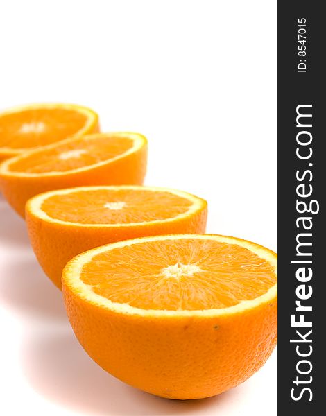 Fresh oranges halves closeup on white