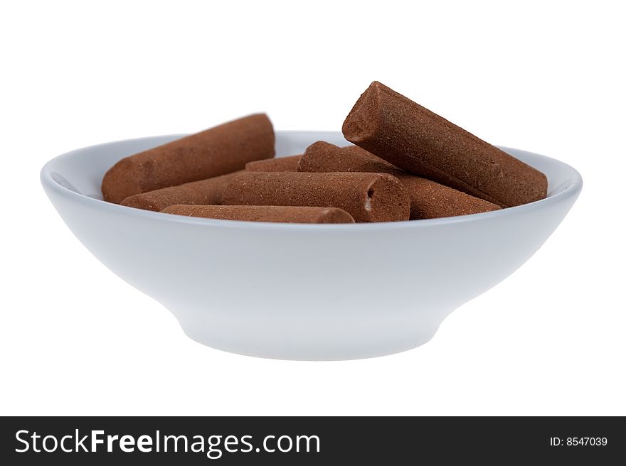 Cinnamon candy sticks in a bowl  isolated on a white background. Cinnamon candy sticks in a bowl  isolated on a white background