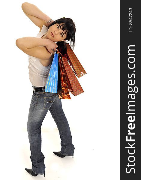 Attractive young woman making shopping with lots of colorful shopping bags, smile and casual wear. Isolated on white. Elevated view. Attractive young woman making shopping with lots of colorful shopping bags, smile and casual wear. Isolated on white. Elevated view