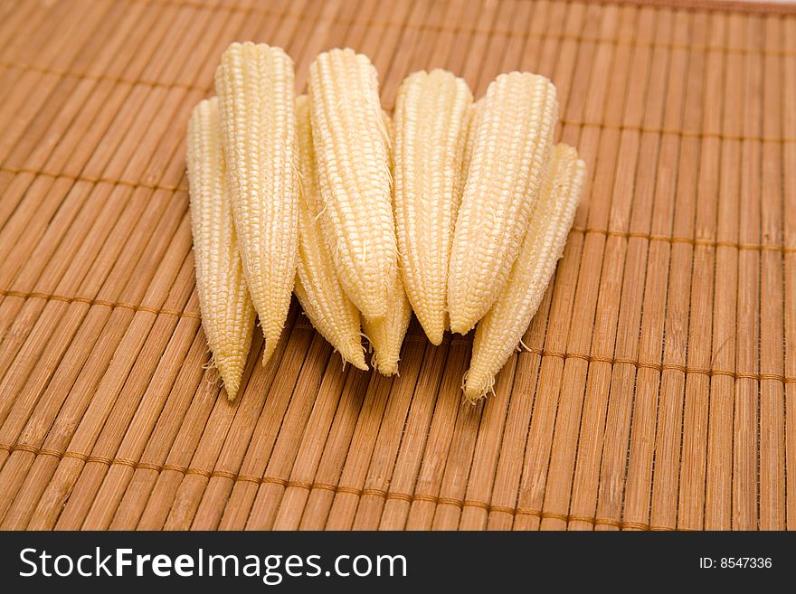 Baby corn on a bamboo laying