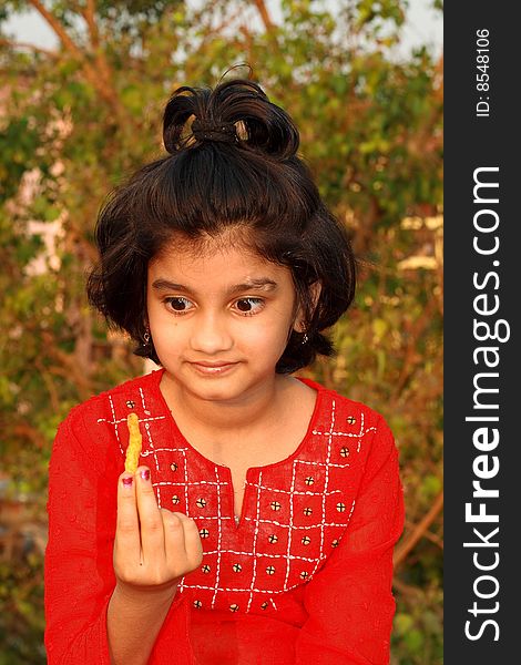 A nice and beautiful Indian girl having a yummy feeling about her snacks. A nice and beautiful Indian girl having a yummy feeling about her snacks.