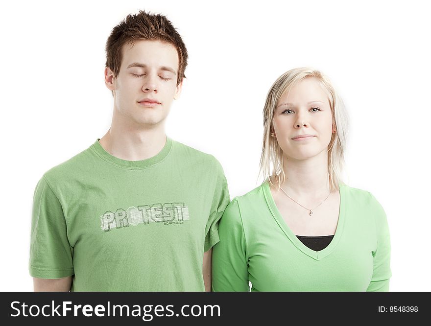Isolated cute young couple in love over white background wearing green shirts