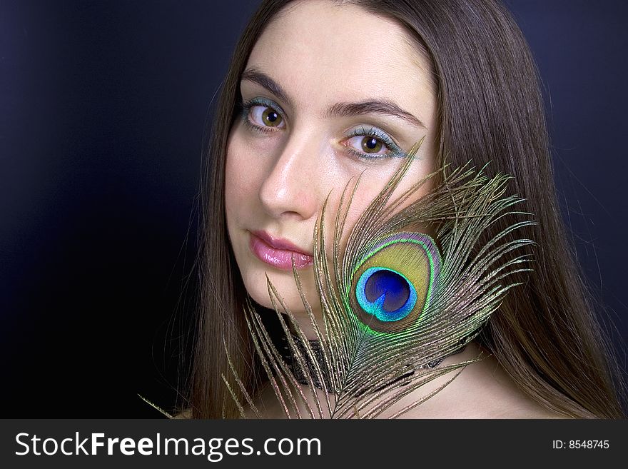 Portrait attractive woman with peacock feather, horizontal. Portrait attractive woman with peacock feather, horizontal