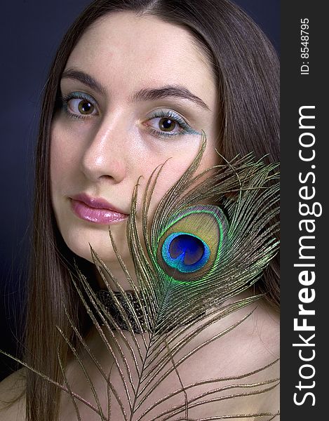 Portrait attractive woman with peacock feather, vertical. Portrait attractive woman with peacock feather, vertical