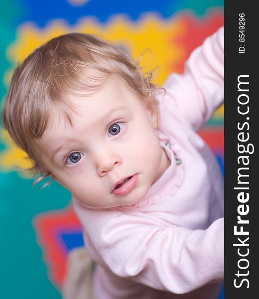 Little girl on varicolored background - shallow DOF