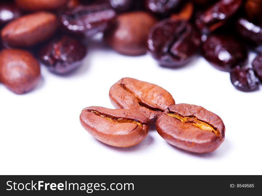 Coffee beans over white background