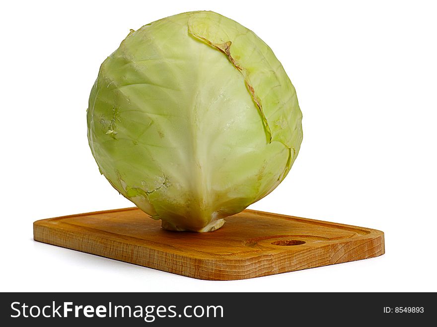 Heads of cabbage on wooden plate
