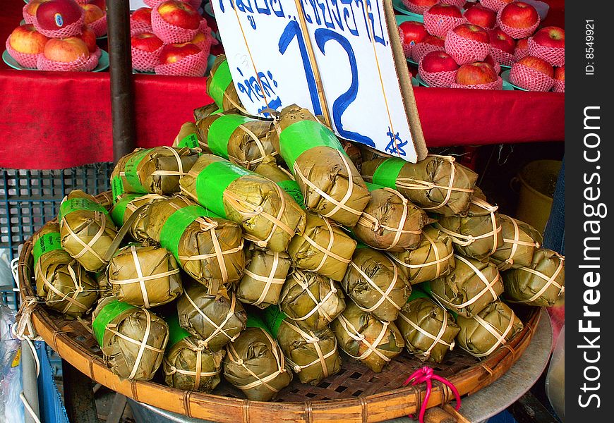A snack wrapped in leaves, sold on Thai market. A snack wrapped in leaves, sold on Thai market