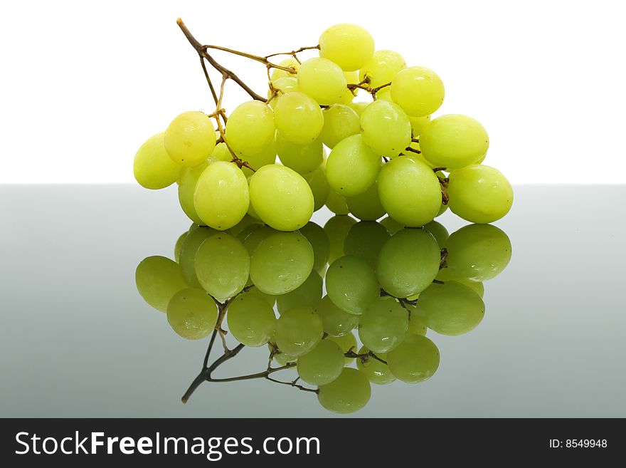 A big string of green grape isolated over white background.