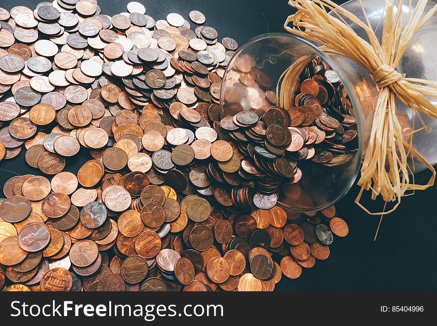 A toppled over jar of pennies. A toppled over jar of pennies.