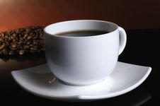 A White Cup Of Coffee And Coffee Beans Stock Images A White Cup Of Coffee And Coffee Beans Stock Images