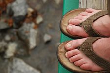 Feet In Sandals Overlooking Stream Royalty Free Stock Photos