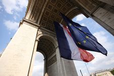 Flags Under Arc De Triomphe Royalty Free Stock Photo