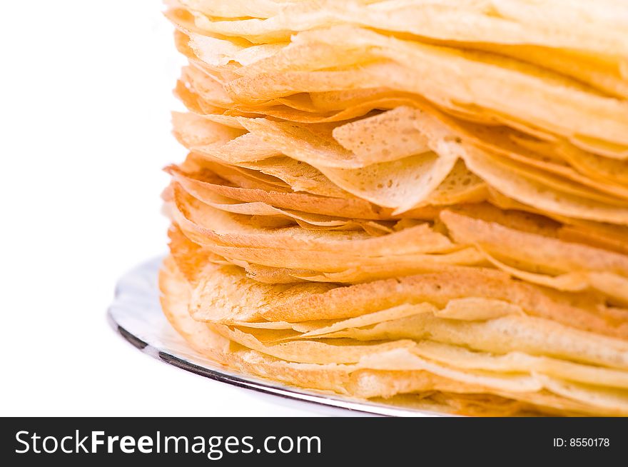 A big stack of pancakes on the white background