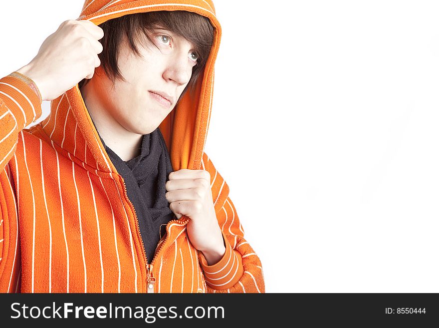 Isolated teen boy in orange hoodie over white background. Isolated teen boy in orange hoodie over white background
