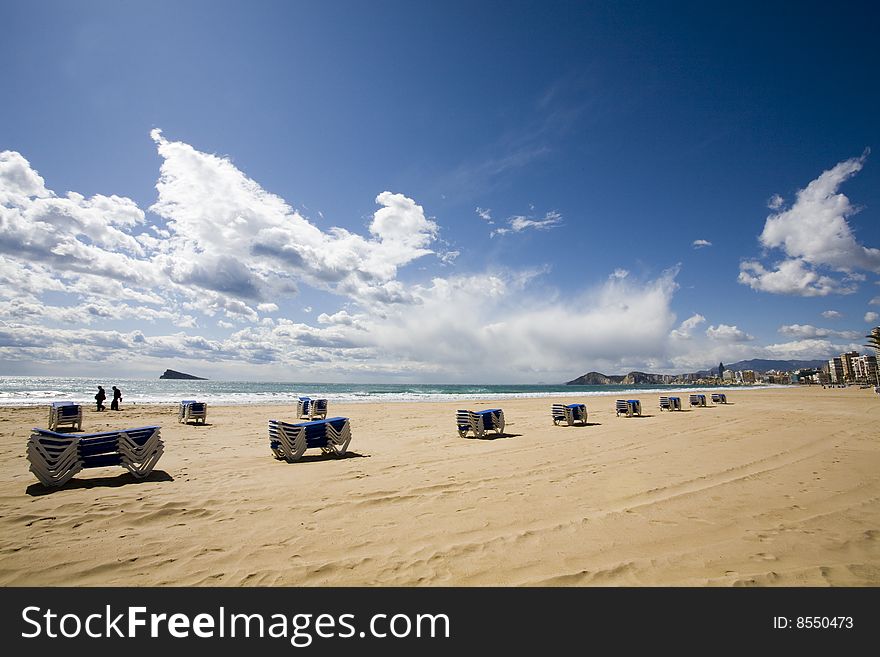 Deck chairs on a beach in benidorm