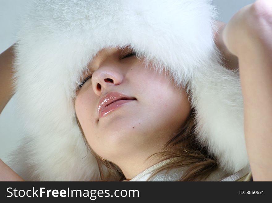 The charming girl in a white fur attire. The charming girl in a white fur attire