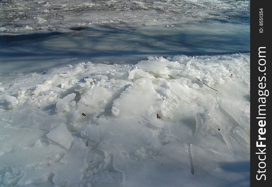 Ice built up on frozen river bank