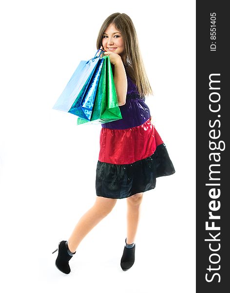 Beautiful young woman holding shopping bags against white background. Beautiful young woman holding shopping bags against white background