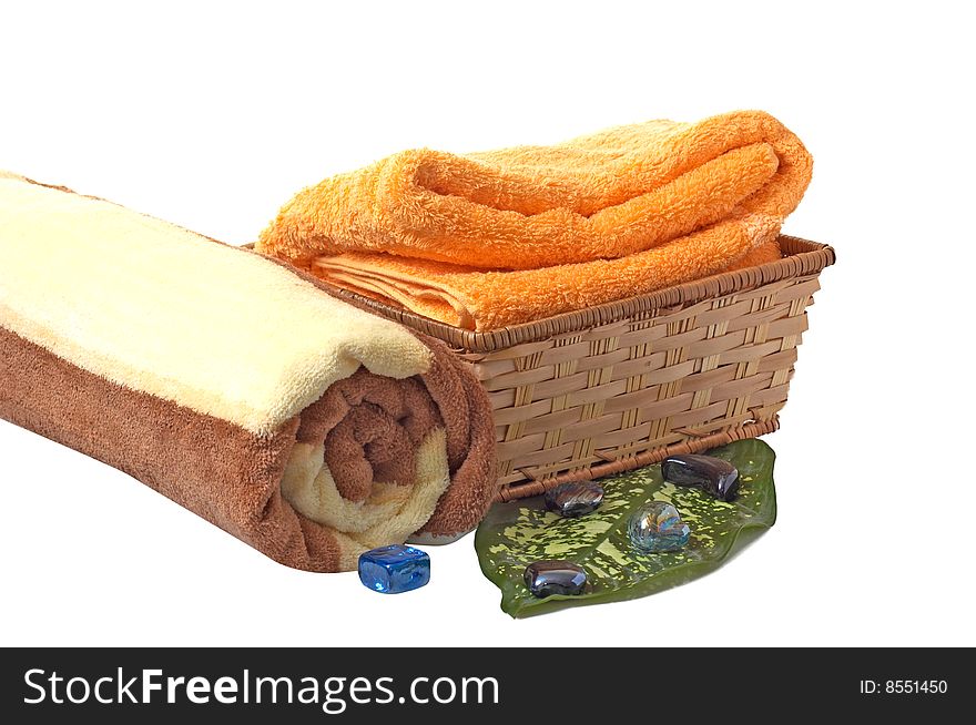 Towels with wonderful stones,green leaf and basket isolated on a white background.