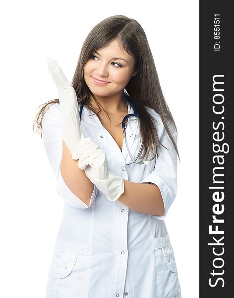 Beautiful doctor dressed in white uniform putting on sterile rubber gloves. Beautiful doctor dressed in white uniform putting on sterile rubber gloves