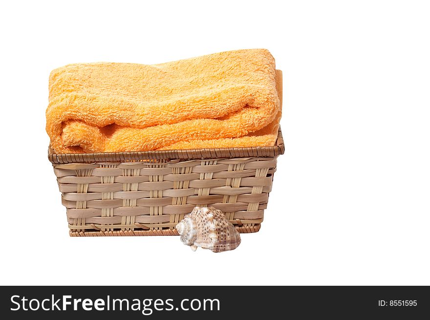 Towel in the basket and seashell isolated on a white background. Towel in the basket and seashell isolated on a white background.