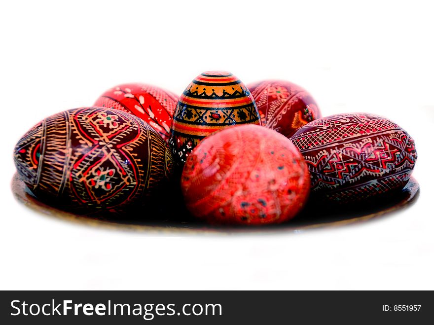 Easter eggs on a wooden plate isolated on a white background