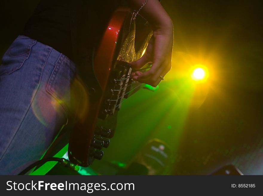 Guitar being played in a concert. Guitar being played in a concert.