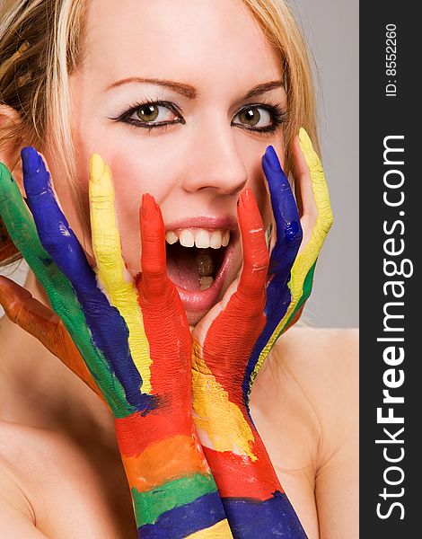 Pretty female model with hands painted rainbow style. Pretty female model with hands painted rainbow style