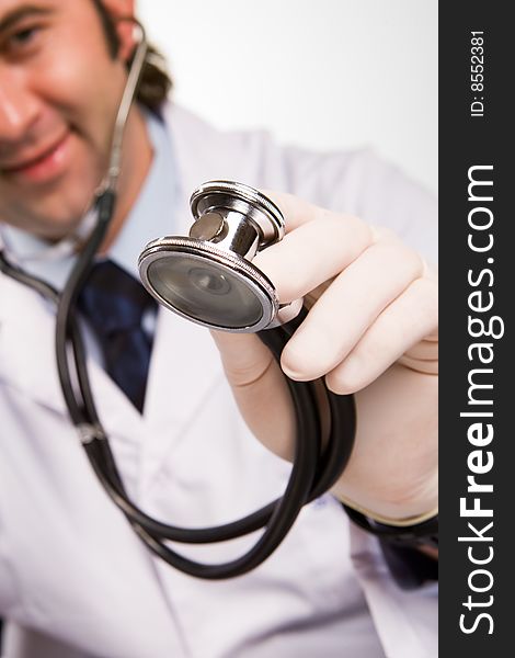 Smiling doctor with stethoscope over white. Smiling doctor with stethoscope over white