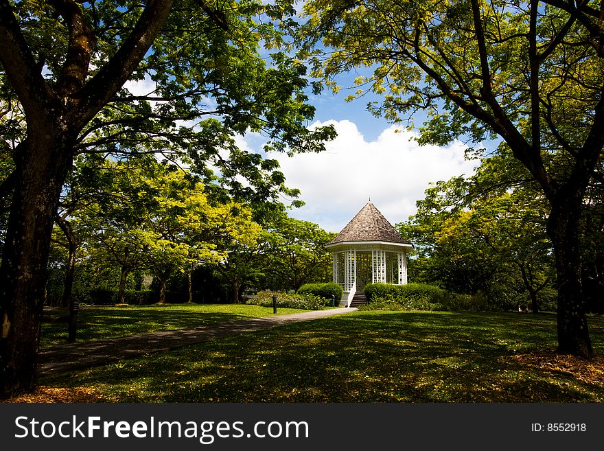 A pavilion in the middle of a garden park. A pavilion in the middle of a garden park.