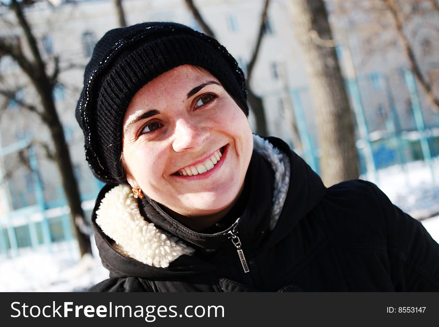 Young woman is smailing outside