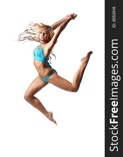 Modern style dancer jumping behind studio background. Modern style dancer jumping behind studio background